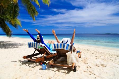 43876070 - happy couple relax on a tropical sand beach